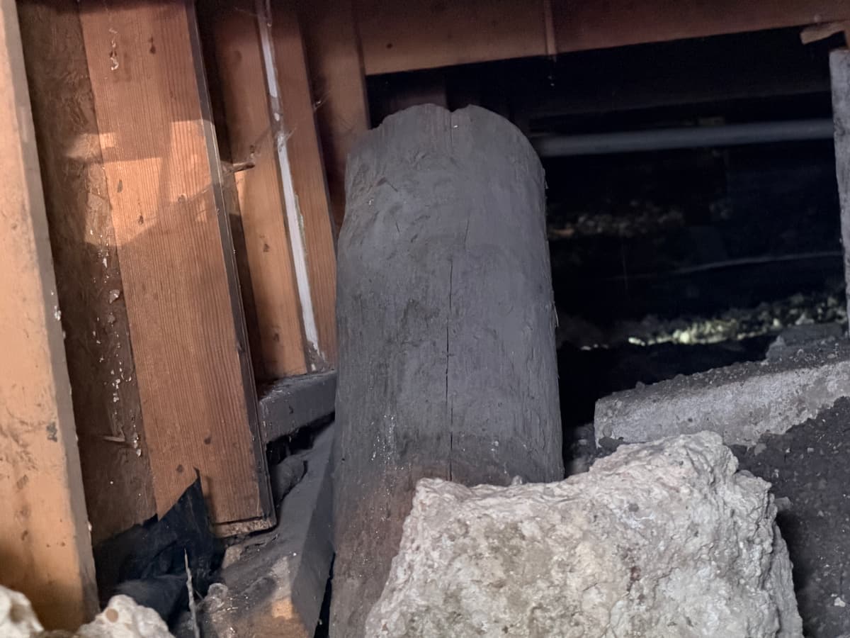 Sagging beam on a makeshift pier in a pier & beam crawl space