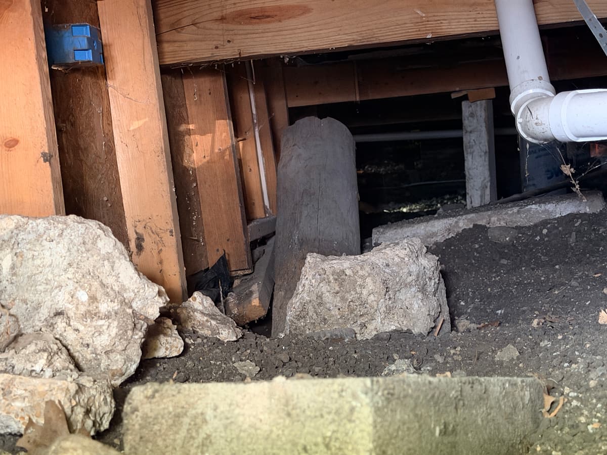Precarious pier under a settling floor beam