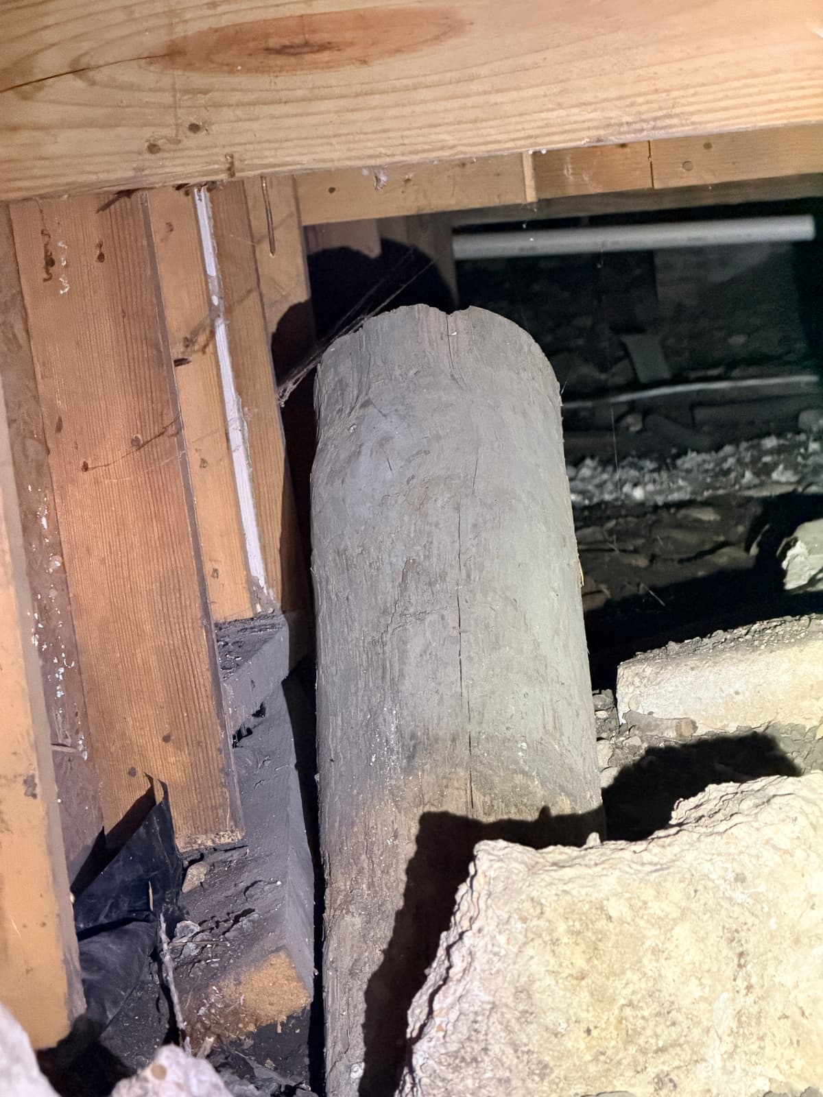 Pier & beam floor beam resting on a settling stacked-rock pier