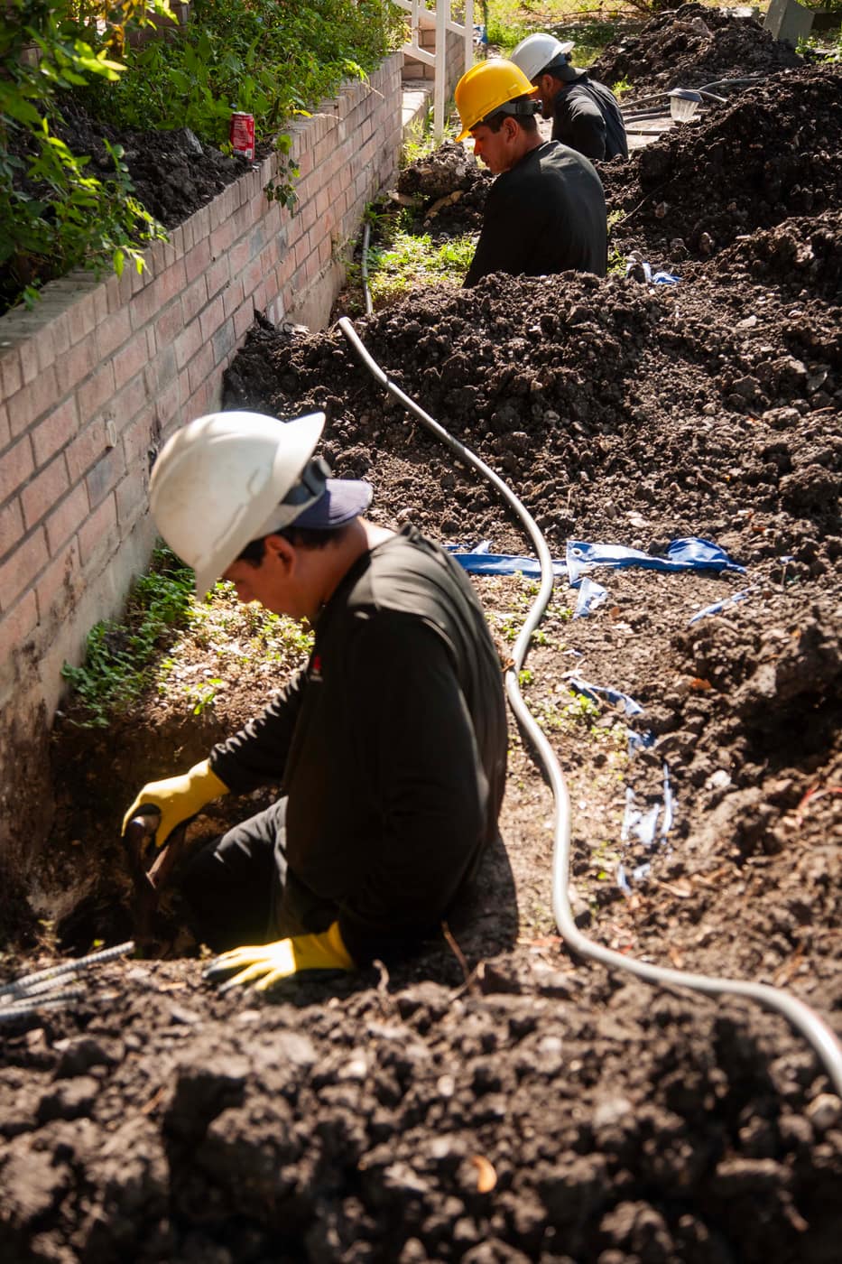 Technician evaluating a foundation pier location