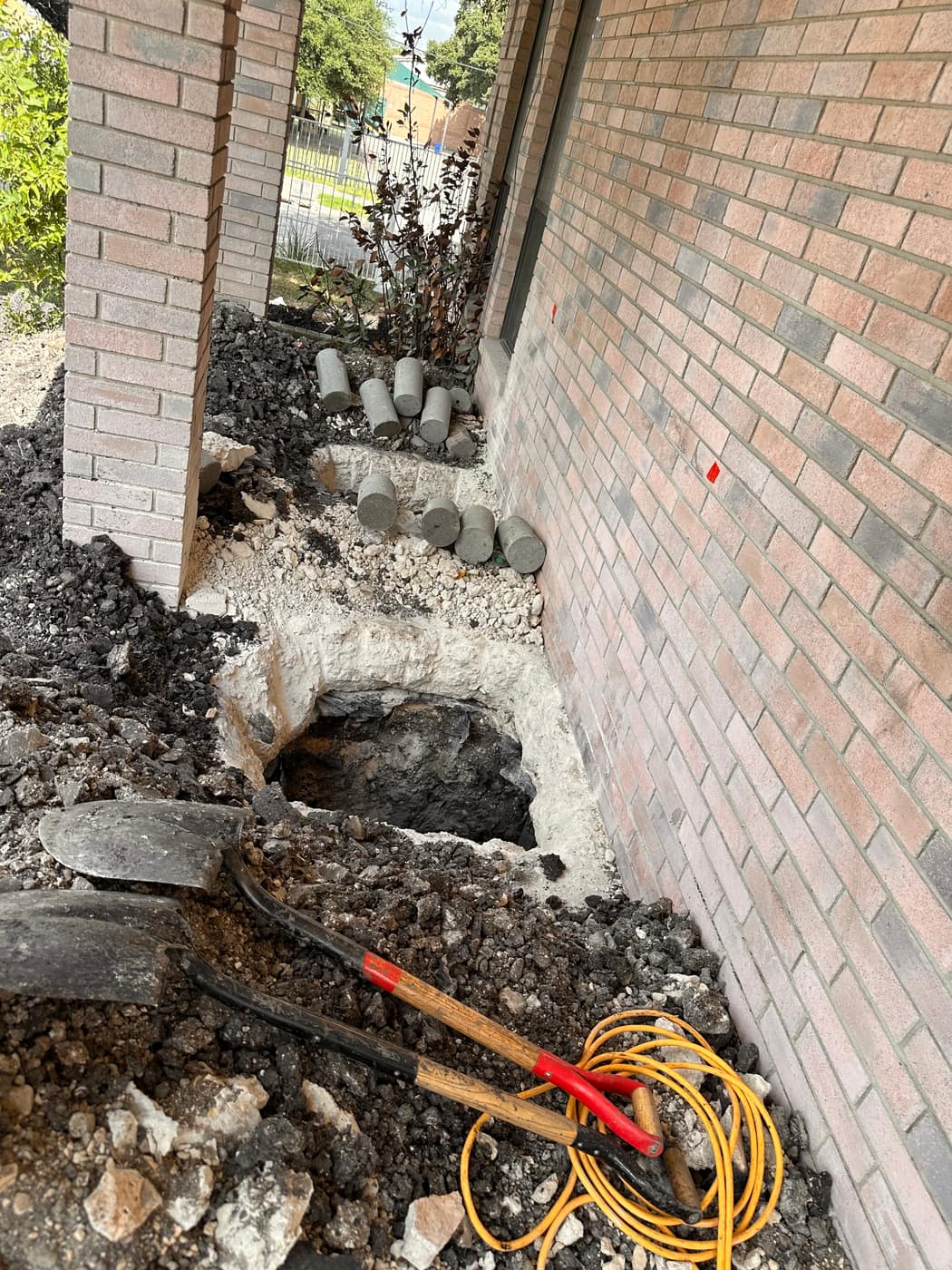 Concrete piers supporting a replaced foundation beam