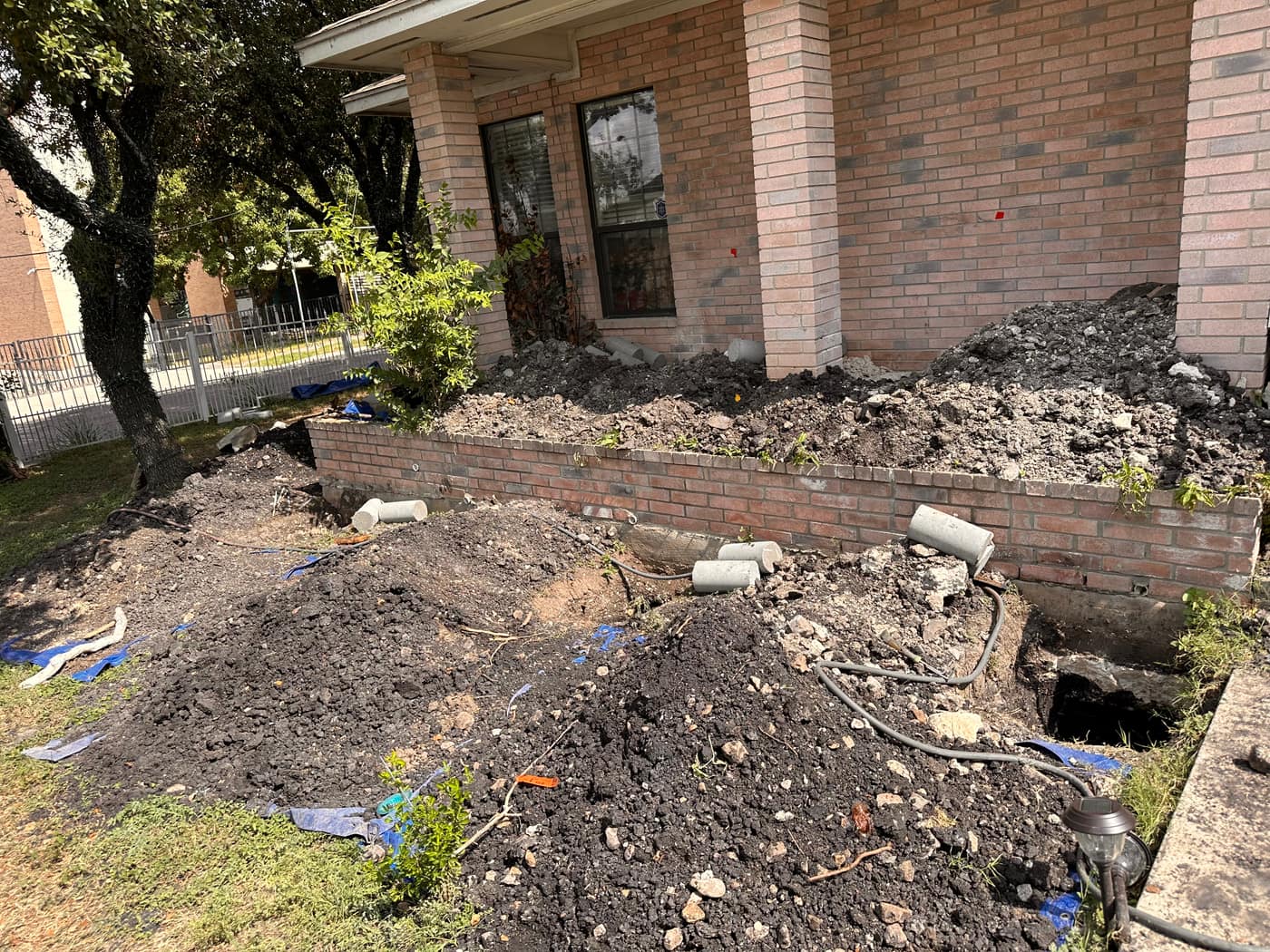 House leveling excavation across the front of a San Antonio home