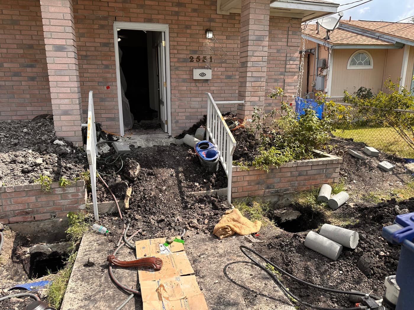 House leveling excavation across the front of a home