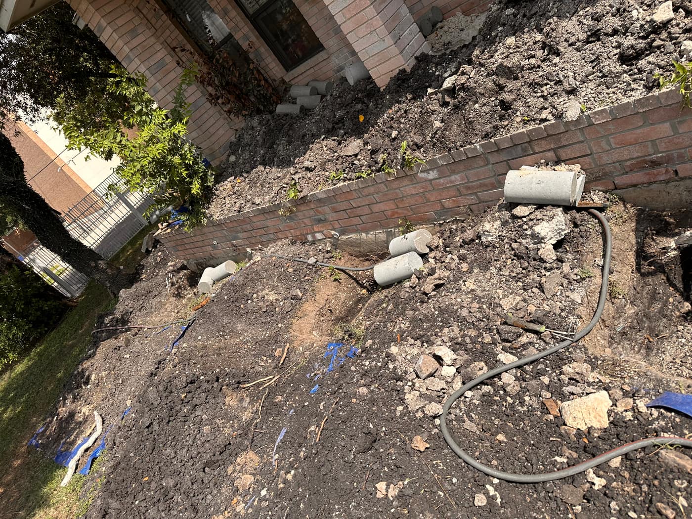 House leveling pier excavation along a foundation