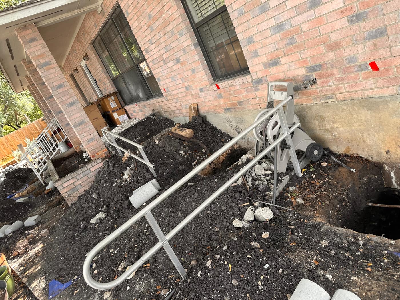 Foundation upkeep along a San Antonio brick home