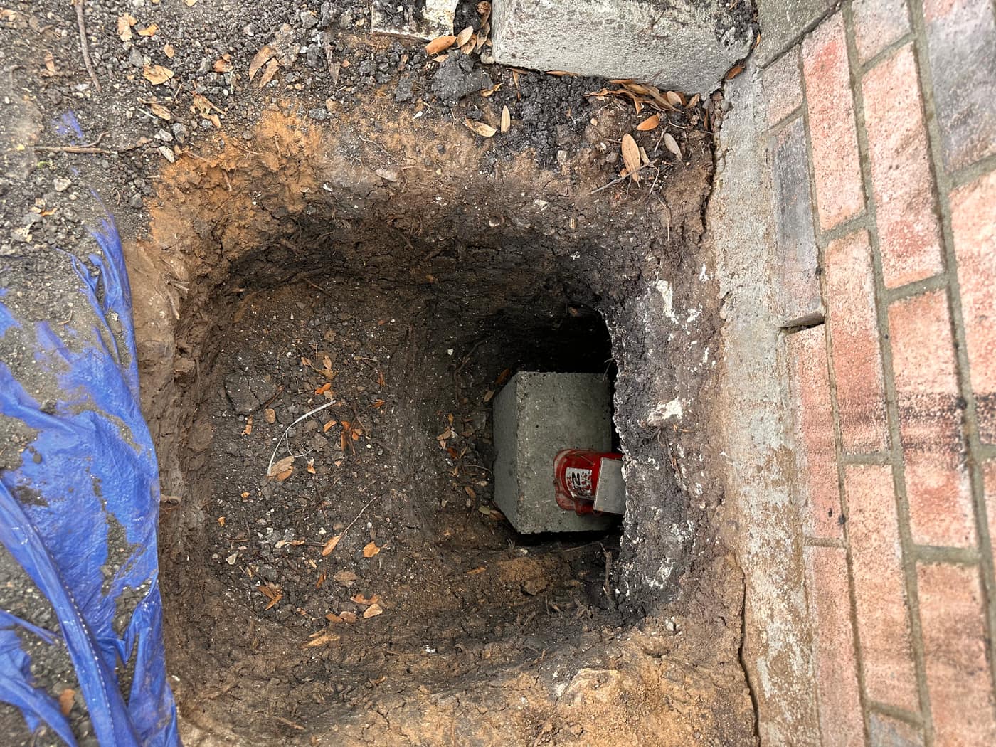 Steel and concrete pier seated in an excavated foundation hole