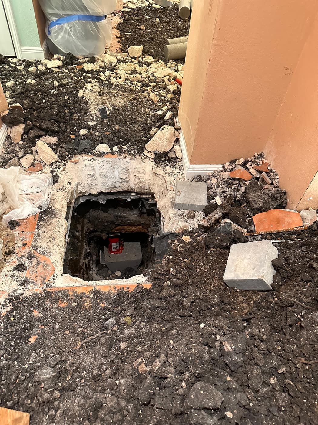 Concrete pier set beneath a slab foundation