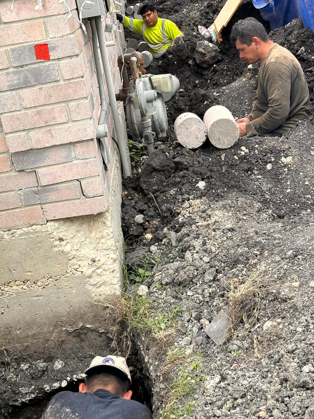Technician setting concrete foundation piers