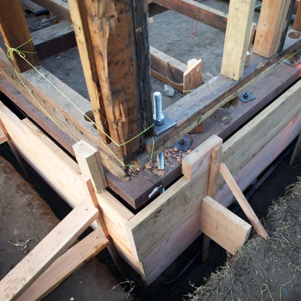 An image showing a house with a stable foundation amidst extreme weather conditions.