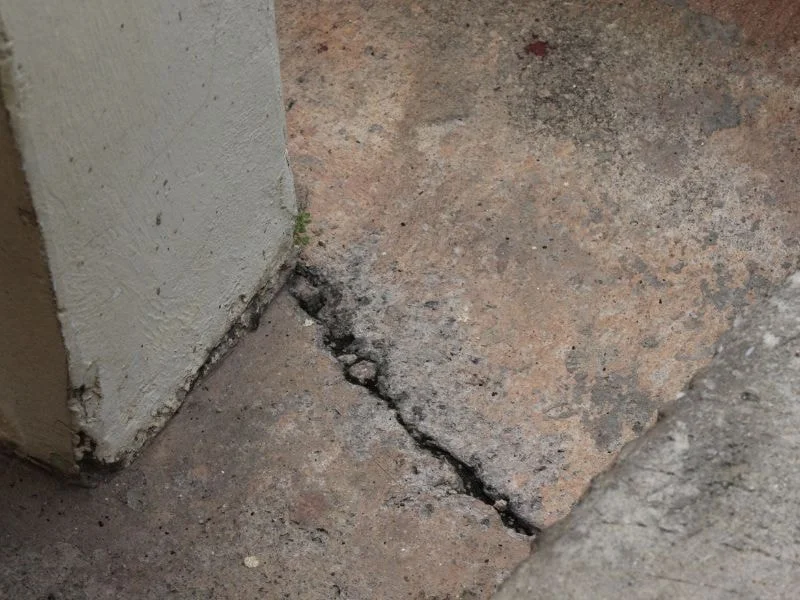 An image showing a house with visible foundation cracks.