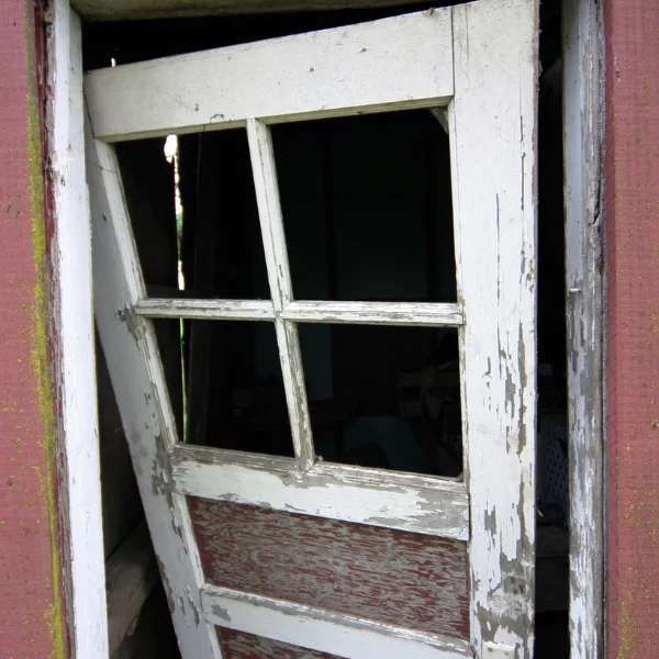 Homeowner struggling with a sticking door due to foundation settling.