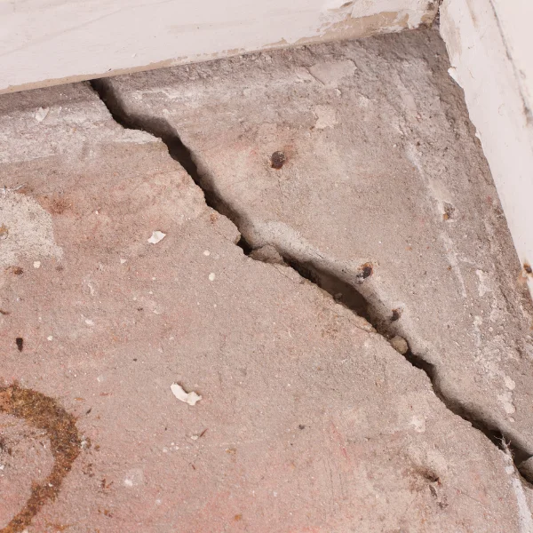 An image of cracks in walls and floors caused by foundation issues.