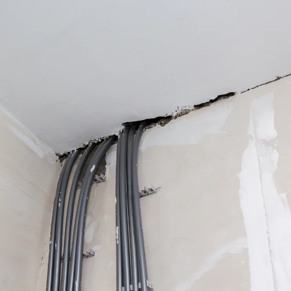 An image showing gaps between walls and ceilings with crown molding separation.