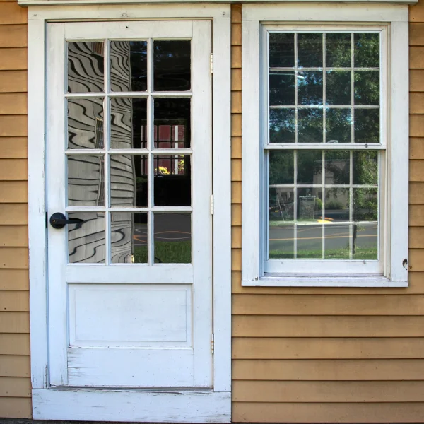 An image showing a door and window that are difficult to open or close due to foundation settling.